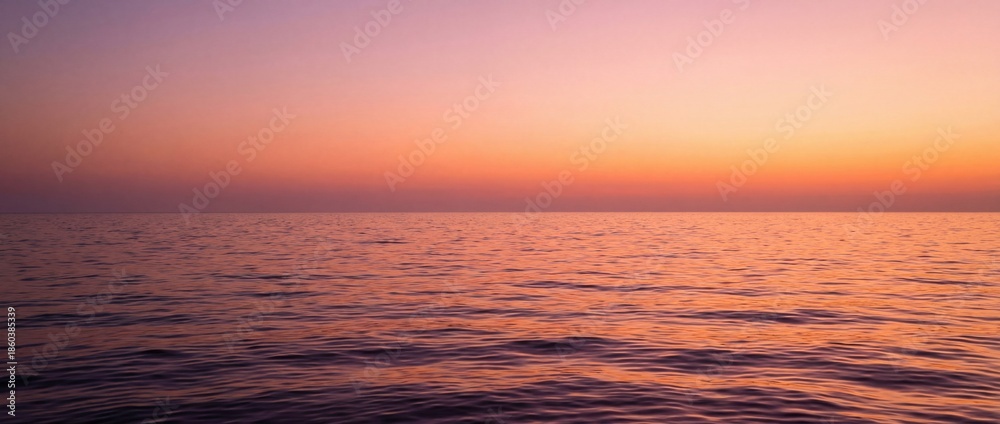 Obraz premium A serene seascape under a gradient sunset, the horizon kissed by the warm hues of twilight. Capturing tranquility and natural beauty.