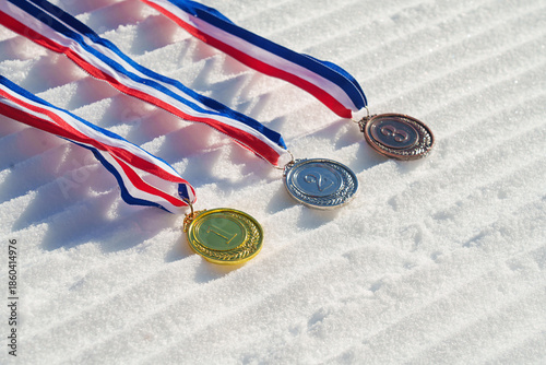 golden medal on the textured ski slopes in the snow - winter sport successful concept. Skiing, biathlon.