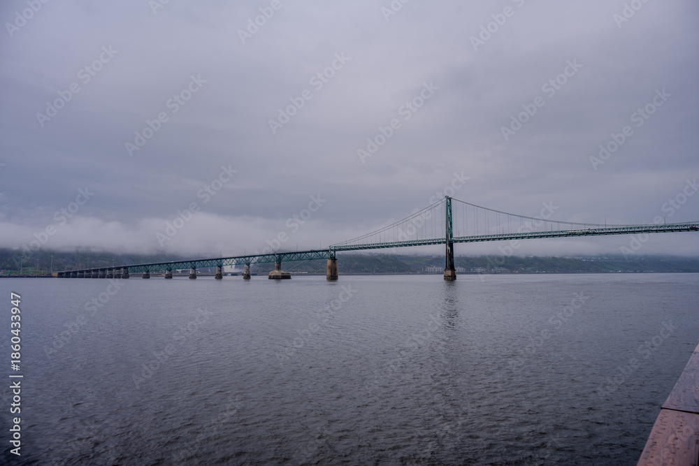 Fototapeta premium Suspension bridge spanning the Saint Lawrence River on a cloudy day