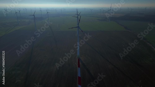 above Wind energy turbines at sunrise, clean power. Magic aerial view drone