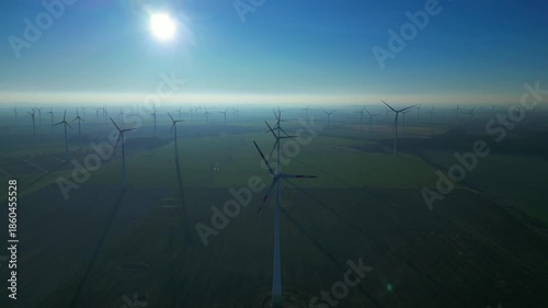 above Wind energy turbines at sunrise, clean power. Best aerial view drone