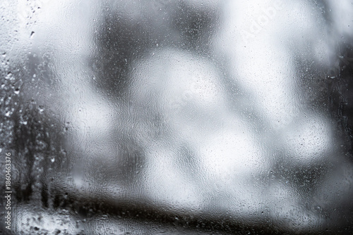 Billede på lærred Close up of water droplets and condensation on a fogged window during rain