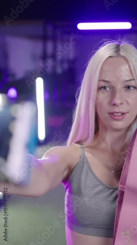 Cute fitness girl influencer record video with smartphone about rubber band