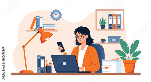 Focused professional woman working at her office desk with a laptop while checking her smartphone for notifications.