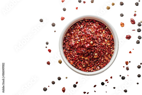 Vibrant red crushed chili flakes in white bowl essential hot spice for on transparent background