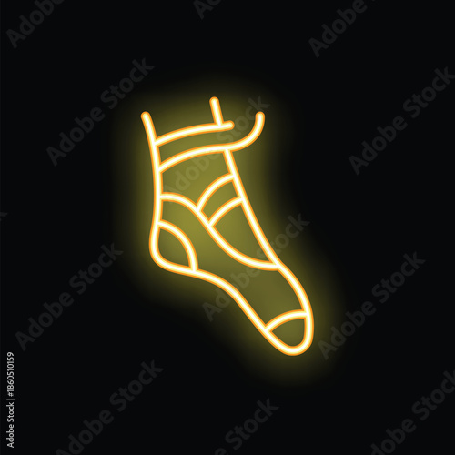Neon sign representing foot wearing ballet shoe on tiptoe on black background