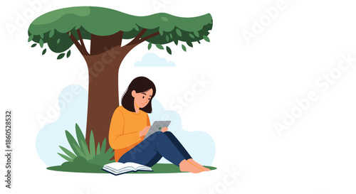 A young woman sitting peacefully under a large tree while reading a book and using a digital tablet in the park.
