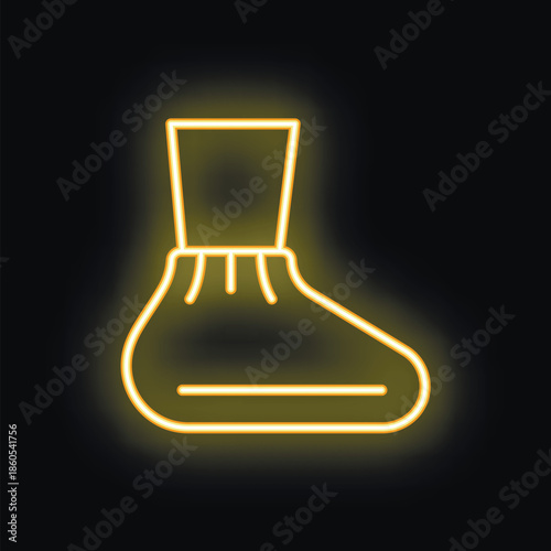 Bright yellow neon sign depicting a shoe cover, glowing on a black background