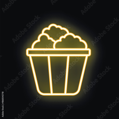 Yellow neon icon of popcorn bucket glowing on black background