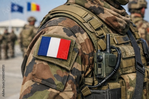 A close-up of a French Army uniform worn by soldiers at a military base, featuring the French flag, photographed in Romania in