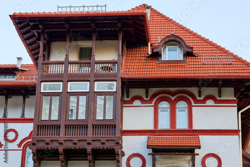 Canvas Print Historic european architecture with ornate red roof and wooden balconies