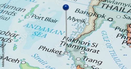 A zoom out of a blue pin into phuket city of Thailand political map
