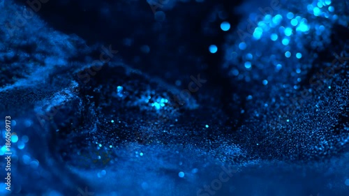 Blue liquid abstract glitter particles flowing on a dark macro surface, creating a smooth cinematic depth effect perfect for visual design, overlays, luxury backgrounds and motion projects.