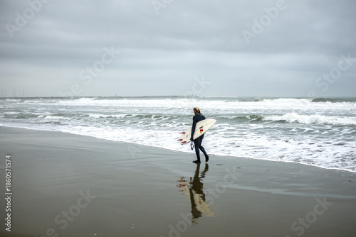 Lone Surfer Walking Toward the Waves