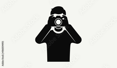 Silhouette of a photographer taking a picture with a camera
