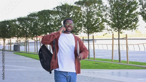 Joyful african american student celebrating good news on phone call