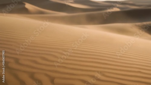 Blurred view of sand dunes in a desert landscape, showcasing the natural patterns and textures of the sand