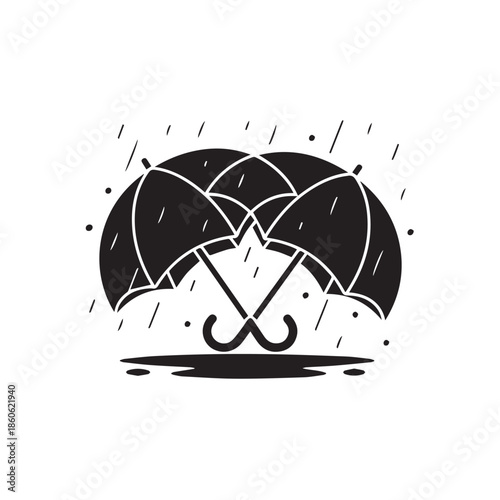 Two black umbrellas in heavy rain with raindrops falling