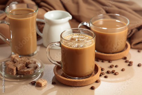 Latte with brown sugar on a beige background.