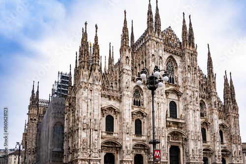 Wallpaper Mural Duomo di Milano cathedral with Gothic spires and detailed marble façade under a bright blue sky. Torontodigital.ca