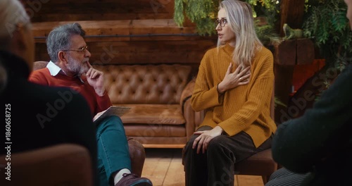 Honest female participant sitting and speaking about personal difficulties during group psychotherapy, sharing openly while receiving calm professional support in a safe environment.