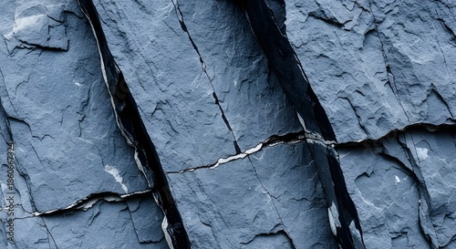 Textured blue-gray stone surface with deep black crevices  