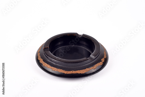 Photos Handcrafted vintage black wooden carved ashtray isolated on the white background
