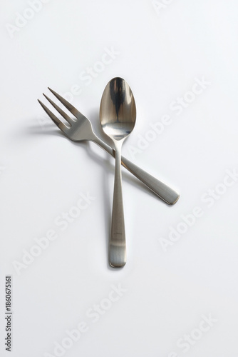Minimal Art Of A Spoon And Fork Crossed Metallic Tones And Soft Shadow