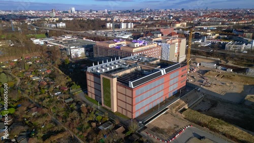 Data center roof with cooling units and solar panels. Dramatic aerial view drone