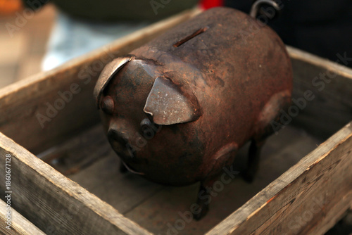 Wrought iron piggy bank for saving coins. Funny investment, business, finance and saving money concept.