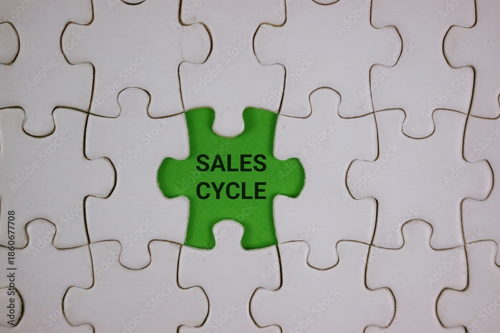 Fototapeta premium Green Puzzle Piece With Sales Cycle Text Among White Pieces Symbolizing Business Growth and Strategy.