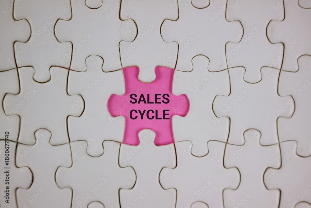 Fototapeta premium Pink Puzzle Piece With Sales Cycle Text Among White Pieces Symbolizing Business Growth and Strategy.