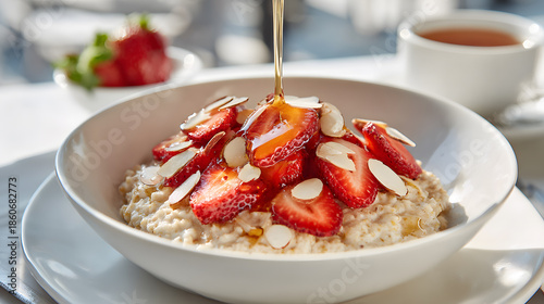 warm oatmeal with strawberries almonds and honey drizzle