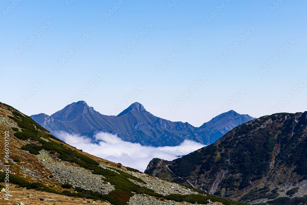 Fototapeta premium Mountain landscape seen from Zawrat Pass with rocky slopes, alpine terrain and distant peaks
