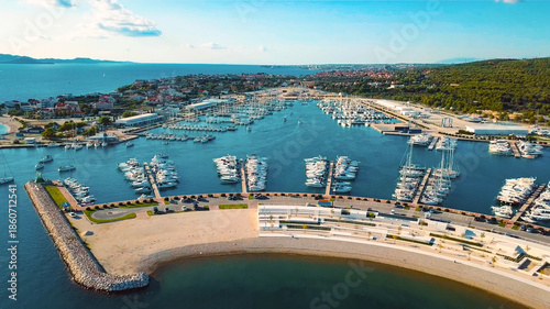 Slika na platnu Aerial view of bay and docks with rock barriers for protection against waves