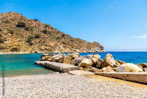 Trapalou trapalo beach on Ikaria island of Greek aegean of Greece by rocky pebbles in Icarian sea crystal clear water by shore coast with wave breaker