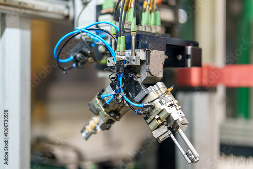 Robotic arm operates machinery in a factory during a work shift handling tasks