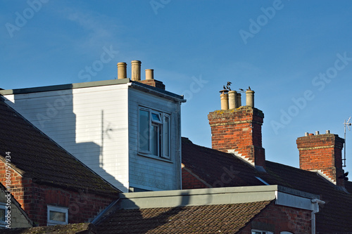 Billede på lærred A terraced house loft conversion next to other rooftops with blue sky background