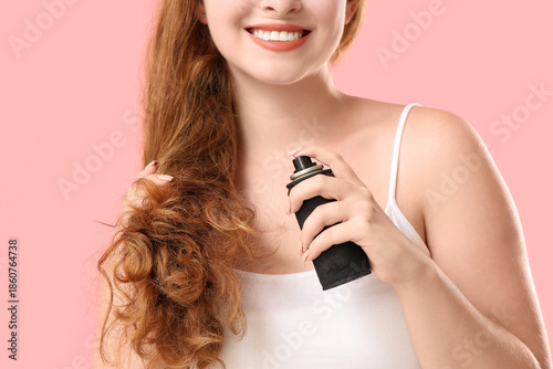 Young redhead woman applyin...
