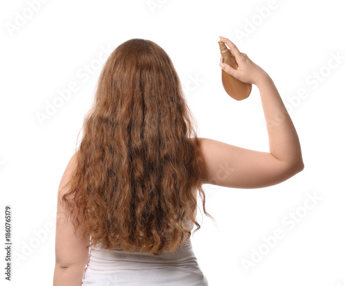 Young redhead woman applyin...