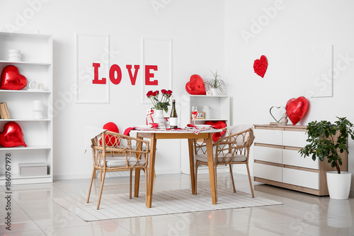 Interior of festive living room with served table and decorations for Valentine's Day celebration