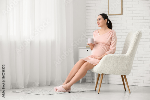 Pregnant woman sitting in c...