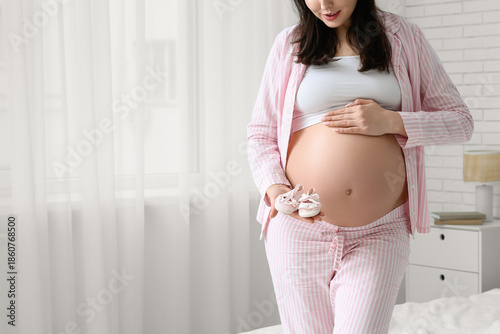 Young pregnant woman in paj...