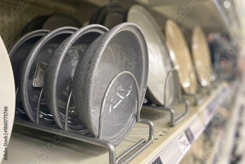 Many plates on the shelf in the store	
