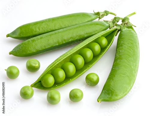 Fresh green pea pods with some open, spilling peas on white surface