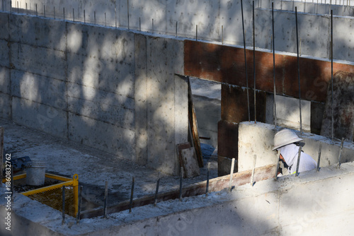 Obraz na płótnie Construction workers removing wood forms from large stormwater retention system