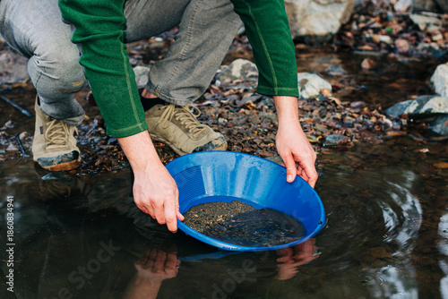 Tablou pe pânză Gold Panning in Mountain Creek Using Blue Pan