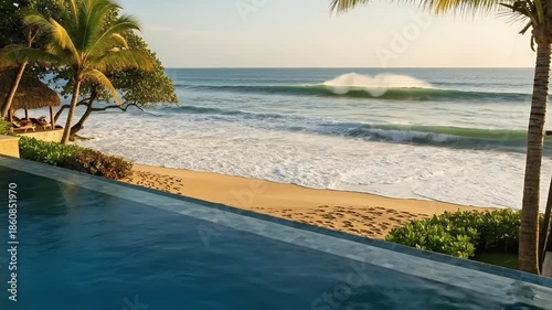 Tropical Beach Infinity Pool With Crashing Waves and Palm Trees at Sunrise Footage