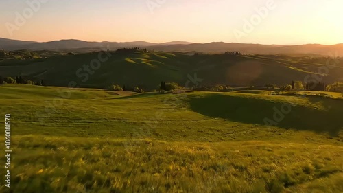 Golden Sunset Light Over Rolling Green Hills of Tuscany