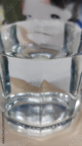 a clear glass of fresh water that moves like waves and then stops